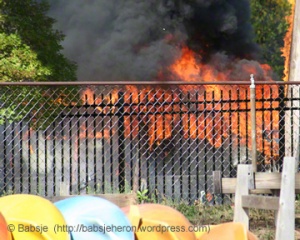 Van fully engulfed in flames on road next to boathouse on Columbus Day weekend - babsjeheron © Babsje (https://babsjeheron.wordpress.com)